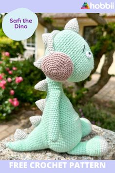 a crocheted dragon sitting on top of a rock with the words free crochet pattern