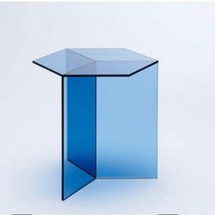 a blue glass table sitting on top of a white floor