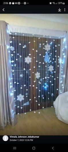 an open door decorated with lights and snowflakes