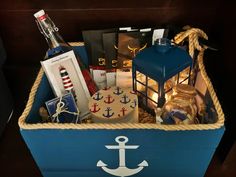 a blue box with an anchor and other items in it sitting on top of a table