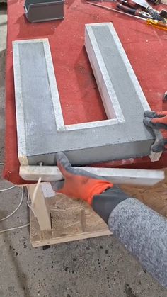 a person is working on some concrete letters