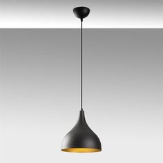 a black and yellow pendant light hanging from a ceiling fixture in an empty room with white walls