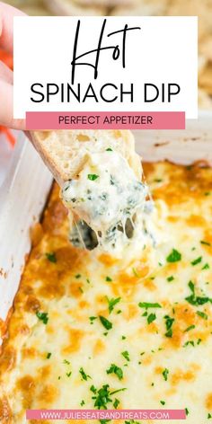 a spoonful of spinach dip is being lifted from a casserole dish