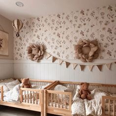 there are two baby cribs in this room with teddy bears on the bed