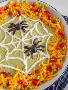 a plate filled with halloween food on top of a blue and white checkered table cloth