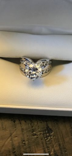 a diamond ring sitting on top of a white box