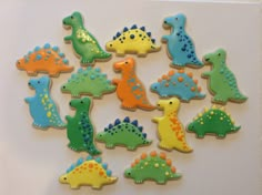 decorated cookies are arranged in the shape of dinosaurs