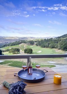 two glasses of wine sitting on top of a wooden table