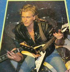 a man playing an electric guitar on the cover of a magazine