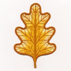 an embroidered leaf is shown on a white background