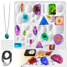 a collection of colorful glass items displayed on a white surface with beads and necklaces