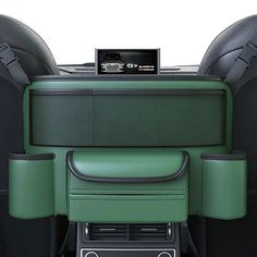 the interior of a car with green leather seats and electronic controls on it's center console