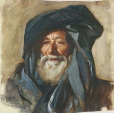 an old man with a black hat and blue shawl on his head is looking at the camera