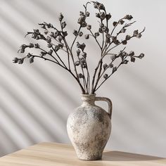 a vase with flowers in it sitting on a table