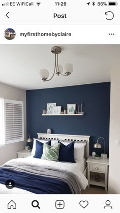 a bedroom with blue walls and white furniture