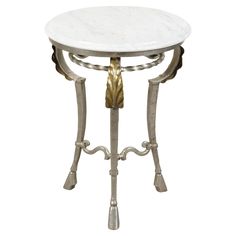 a white marble table with metal legs and gold trimmings on the top, against a white background