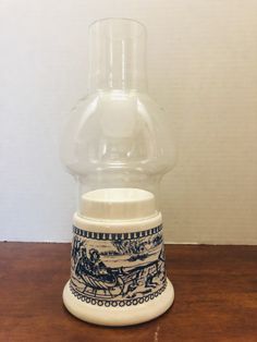 a glass vase sitting on top of a wooden table