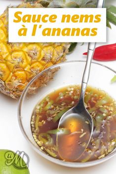 a bowl filled with soup next to a pineapple and a sign that says sauce nens d'ananas