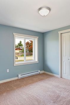 an empty room with blue walls and carpet