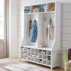 a white coat rack filled with coats and shoes