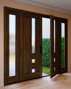 an open wooden door with glass panels on the inside and outside doors that lead out to a green lawn