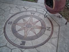 a compass is on the ground next to a fire hydrant and potted plant