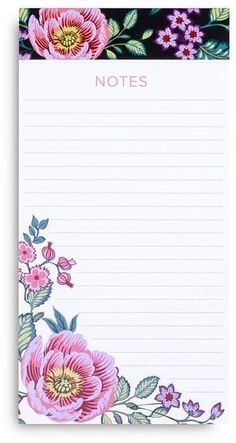 a notepad with pink flowers and leaves on the front, next to a black background