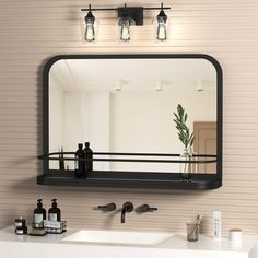 a bathroom sink with a mirror above it and some bottles on the counter next to it