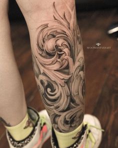 a woman's leg with an artistic tattoo design on her left arm and foot