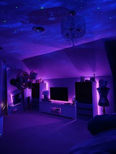 a room with purple lighting and decorations on the ceiling, in front of a flat screen tv