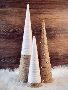 two christmas trees made out of burlock and twine on a white furnishing