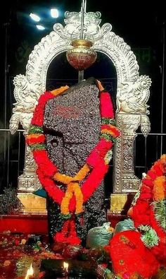 the statue is decorated with flowers and garlands