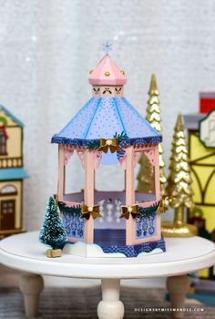 a carousel on a table with christmas trees in the background