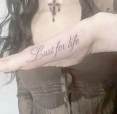 a woman's arm with the words just for life tattooed on her left hand