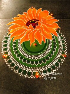 an orange flower is on top of a green doily with white dots and lights