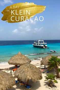 a boat is in the water near some straw umbrellas and palm trees on the beach