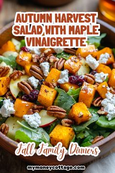 autumn harvest salad with maple vinaigrette and pecanized walnuts in a wooden bowl