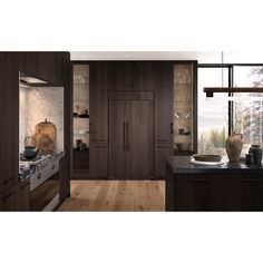 a kitchen with wooden floors and dark wood cabinets