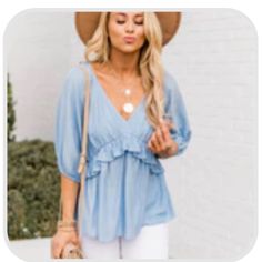 This Romantic Blue Blouse Is Such An Amazing Choice For Any Occasion! We Love The Cut Of The Babydoll Style And The Classic Blue Color. This Blouse Also Features A V-Neck And A Ruffle Along The Bust Line. Never Worn. Blue Ruffle Hem Top For Beach, Cute Ruffled Beach Blouse, Cute Blue Summer Blouse, Cute Light Blue V-neck Top, Cute V-neck Blouse For The Beach, Cute V-neck Blouse For Beach, Summer Blouse With Ruffles In Light Wash, Light Wash Ruffled Blouse For Summer, Blue Ruffled Beach Blouse