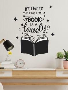 a wall decal that reads between the pages of a book is a lovely place to be