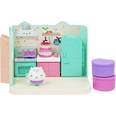 a toy kitchen with an oven, refrigerator and cupcake