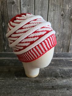 a white and red knitted hat on top of a mannequin's head