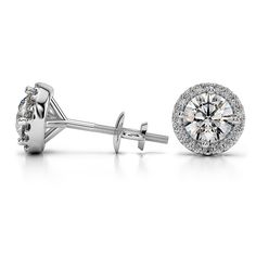 These beautiful diamond stud earrings feature two round cut diamonds in a white gold prong setting that are encircled in a halo of pave set diamonds. Each G color, VS2 clarity, Excellent cut center diamond weighs 0.36 carat, for a total diamond weight of 1 carat. Round Diamond Earrings, Gold Diamond Hoop Earrings, Halo Diamond Earrings, Mohs Scale, Diamond Tester, Round Halo, Top 10 Engagement Rings, Halo Earrings, Rock Salt