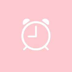 an alarm clock on a pink background