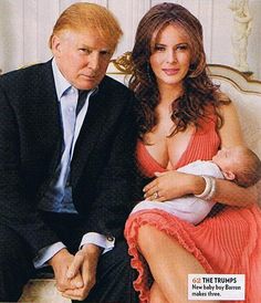 a man sitting next to a woman holding a baby on top of a magazine cover