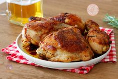 some chicken is sitting in a white bowl on a red and white checkered cloth