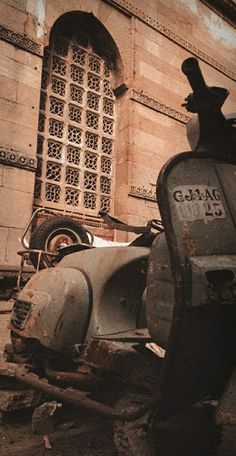 an old scooter parked in front of a building