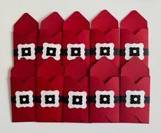 several red envelopes with black and white trim are lined up against each other on a white surface