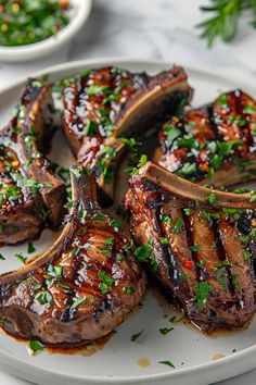 grilled steaks on a plate with garnishes and parsley sprigs