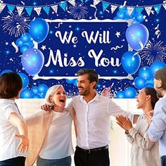 a group of people standing around each other in front of a sign that says, we will miss you